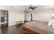 Large main bedroom showing walk in closet, hardwood floors, and modern ceiling fan at 10720 Breaking Rocks Dr, Tampa, FL 33647