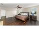 Spacious main bedroom with hardwood floors, ceiling fan, and double-door closet at 10720 Breaking Rocks Dr, Tampa, FL 33647