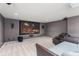 Comfortable media room with a large screen, surround sound system, plush seating, and soft carpet flooring at 10720 Breaking Rocks Dr, Tampa, FL 33647