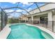 Spacious screened-in pool area with a spa, patio, and safety fence at 10720 Breaking Rocks Dr, Tampa, FL 33647
