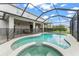 Inviting screened-in pool and spa area with patio and safety fence at 10720 Breaking Rocks Dr, Tampa, FL 33647