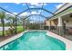 Relaxing screened-in pool and spa with lush landscaping, and a covered patio area at 10720 Breaking Rocks Dr, Tampa, FL 33647