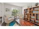 Bright sitting room with armchairs, a bookshelf, and large window offering natural light at 10720 Breaking Rocks Dr, Tampa, FL 33647