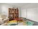 Cozy sitting room with a comfortable armchair, bookshelves, and a stylish rug at 10720 Breaking Rocks Dr, Tampa, FL 33647