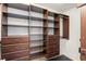 Walk-in closet offering wood shelving and drawer storage to keep clothes organized at 10720 Breaking Rocks Dr, Tampa, FL 33647