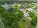 Aerial view of house and its backyard featuring a beautiful pool and a trampoline at 1302 Georgetowne Cir, Sarasota, FL 34232
