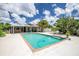 A shimmering pool is centrally located in the home's private backyard at 1302 Georgetowne Cir, Sarasota, FL 34232