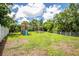 Backyard featuring a playground set, swings, and a trampoline, perfect for Gathering fun at 1302 Georgetowne Cir, Sarasota, FL 34232