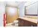 Bathroom featuring a shower and a granite countertop sink with dark wood cabinets at 1302 Georgetowne Cir, Sarasota, FL 34232