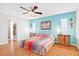Bedroom featuring a ceiling fan, wood floors, and ample natural light from a window at 1302 Georgetowne Cir, Sarasota, FL 34232