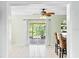 Bright dining area with tiled floors and access to a screened patio through sliding glass doors at 1302 Georgetowne Cir, Sarasota, FL 34232