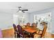 Well-lit dining room featuring wood floors, a ceiling fan, and seamlessly connected kitchen at 1302 Georgetowne Cir, Sarasota, FL 34232