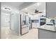 Well-lit kitchen featuring stainless steel appliances, white cabinets, and an open concept layout at 1302 Georgetowne Cir, Sarasota, FL 34232