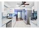 Modern kitchen featuring white cabinets, stainless steel appliances, and granite countertops at 1302 Georgetowne Cir, Sarasota, FL 34232