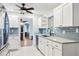 Modern kitchen featuring white cabinets, stainless steel appliances, and granite countertops at 1302 Georgetowne Cir, Sarasota, FL 34232