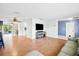 Spacious living room with hardwood floors, an entertainment center, and an open layout at 1302 Georgetowne Cir, Sarasota, FL 34232