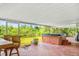 Relaxing screened outdoor spa with verdant views; perfect for tranquil moments at 1302 Georgetowne Cir, Sarasota, FL 34232