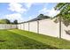 Fenced backyard with lush green grass and a tall privacy fence at 23109 Emerson Way, Land O Lakes, FL 34639