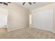 Cozy bedroom featuring ceiling fan, wall-to-wall carpet, double door closet and ensuite bathroom at 23109 Emerson Way, Land O Lakes, FL 34639