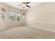 Bedroom features large windows, neutral carpet and ceiling fan at 23109 Emerson Way, Land O Lakes, FL 34639