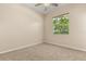Bedroom featuring neutral walls, ceiling fan, one window allowing natural light and carpeted floor at 23109 Emerson Way, Land O Lakes, FL 34639