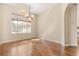 Dining room showcasing hardwood floors and large window with natural light at 23109 Emerson Way, Land O Lakes, FL 34639