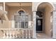 Elegant front entrance with decorative columns and a stylish black door at 23109 Emerson Way, Land O Lakes, FL 34639
