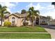 Charming single-story home featuring a lush front yard and tropical landscaping at 23109 Emerson Way, Land O Lakes, FL 34639