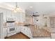 Open kitchen featuring white cabinets, granite countertops, and a breakfast bar at 23109 Emerson Way, Land O Lakes, FL 34639