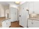 Bright white kitchen featuring granite countertops, light wood floors and stainless appliances at 23109 Emerson Way, Land O Lakes, FL 34639