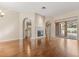 Spacious living room with hardwood floors, fireplace, and access to the lanai at 23109 Emerson Way, Land O Lakes, FL 34639