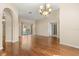 Bright living room with wood floors, chandelier, and sliding glass doors to the pool area at 23109 Emerson Way, Land O Lakes, FL 34639