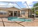 Screened-in pool area with brick pavers and a kidney-shaped swimming pool, perfect for outdoor fun at 23109 Emerson Way, Land O Lakes, FL 34639