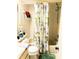 Cozy bathroom featuring a floral curtain rod with a built-in tub and shower at 6640 121St Ave # 1, Largo, FL 33773
