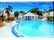 Community pool and recreational area with a view of the clubhouse, perfect for relaxation and leisure at 6640 121St Ave # 1, Largo, FL 33773