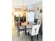 View of a dining room and kitchen with four chairs around a glass table at 6640 121St Ave # 1, Largo, FL 33773