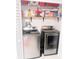 Modern laundry room with stainless steel front-load washer and dryer at 6640 121St Ave # 1, Largo, FL 33773
