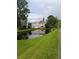 Scenic view of the community pond, reflecting the colorful townhomes and lush green landscaping at 6640 121St Ave # 1, Largo, FL 33773