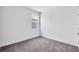 Cozy bedroom with gray carpet, a large window, and neutral walls, perfect for relaxation and rest at 9581 Vibrant Lane, Venice, FL 34292