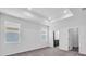 Large bedroom with trey ceiling, two windows and neutral walls and carpeted floors at 9581 Vibrant Lane, Venice, FL 34292