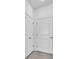 Hallway with a tiled floor, a storage closet and access door at 9581 Vibrant Lane, Venice, FL 34292