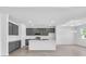 Spacious kitchen with gray cabinets, a white island, stainless appliances, and ample counter space for cooking at 9581 Vibrant Lane, Venice, FL 34292