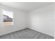 Bright, carpeted bedroom with a large window offering plenty of natural light at 9596 Vibrant Lane, Venice, FL 34292