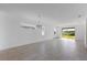 Spacious living room featuring tile floors, recessed lighting, and large sliding glass doors leading to the outside at 9596 Vibrant Lane, Venice, FL 34292
