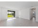 Bright, open living space with tile flooring and sliding glass doors providing access to the outdoors at 9596 Vibrant Lane, Venice, FL 34292