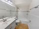 Bathroom featuring a tiled tub and shower, modern sink, and neutral color palette at 10344 Rosemount Dr, Tampa, FL 33624