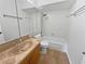 Cozy bathroom featuring tiled flooring, tiled walls around the tub, and a single sink vanity at 10344 Rosemount Dr, Tampa, FL 33624