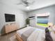 Modern bedroom with a ceiling fan, window, neutral tones, and ample natural light at 10344 Rosemount Dr, Tampa, FL 33624