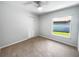Cozy bedroom with carpet flooring, neutral paint, and a window that welcomes natural light at 10344 Rosemount Dr, Tampa, FL 33624