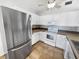 Bright kitchen with stainless steel appliances, white cabinetry, tiled backsplash, and tile floor at 10344 Rosemount Dr, Tampa, FL 33624